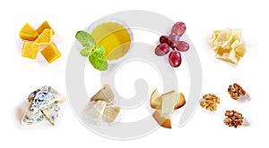 Different type of cheese with honey, grape, nuts on white background. Top view. Blue cheese, cheddar, parmesan, maasdam