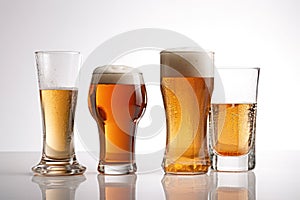 Different types of beer in glasses and bottles, isolated on white