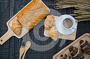 Different types of bread and bakery on a wooden background