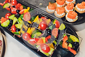 Different types of canapes on buffet table.