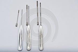 Different types of catheter trocars on grey surface