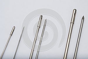 Different types of catheter trocars on grey surface