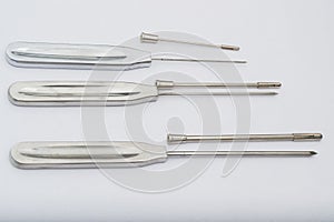 Different types of catheter trocars on grey surface
