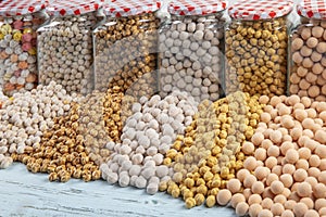 Different types of chickpeas in glass jars,white chickpeas,coated chickpeas,sugar coated chickpeas,salty chickpeas