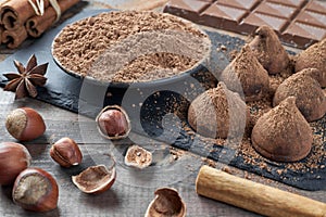 Different types of chocolate, cocoa powder, hazelnuts and other spices.