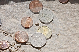 Different types of coins on stone