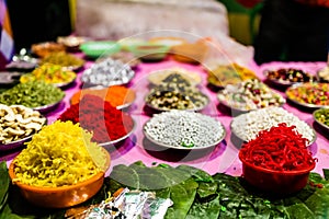 Different types of colorful garnish pan masala used to decorate betel leaf banarasi paan.