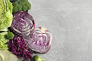 Different types of cut cabbage on light grey table, flat lay. Space for text