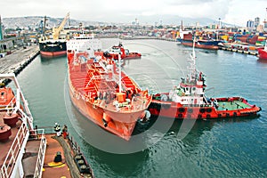 Different types of dry cargo, passenger and container vessels in motion and moored at the port of Izmir, Turkey. photo
