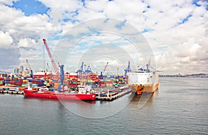 Different types of dry cargo, passenger and container vessels in motion and moored at the port of Izmir, Turkey.