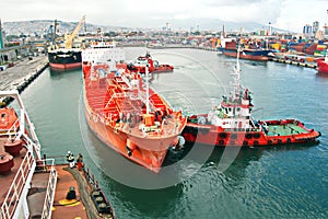 Different types of dry cargo, passenger and container vessels in motion and moored at the port of Izmir, Turkey.