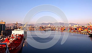 Different types of dry cargo, passenger and container vessels in motion and moored at the port of Izmir, Turkey.