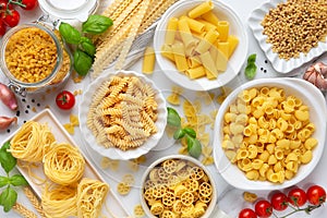 Different types of dry Italian pasta in bowls