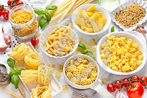 Different types of dry Italian pasta in bowls