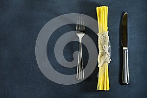 Different types of dry Italian pasta on a dark blue background.