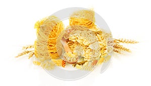 Different types of dry pasta with wheat ears isolated on white