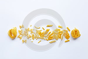 Different types of dry pasta on white