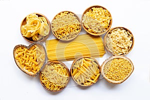 Different types of dry pasta on white