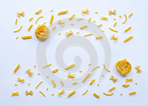 Different types of dry pasta on white