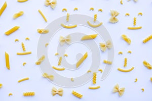 Different types of dry pasta on white