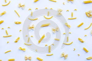 Different types of dry pasta on white