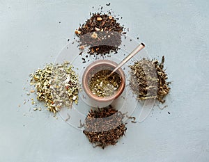 different types of dry tea, in the middle of a calabas with mate . Tea party concept photo