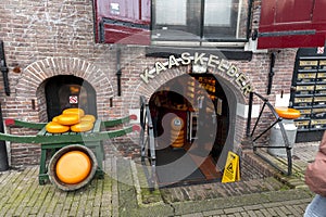 Different types of Dutch cheese wrapped and stacked in a grocery shop in Amsterdam