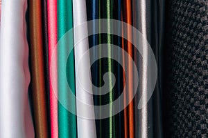 Different types of fabrics are stacked in a row