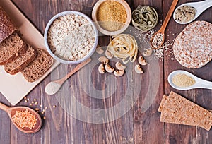 Different types of high carbohydrate food on the wooden background