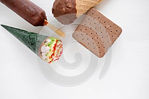 Different types of ice cream on a light wooden background with a place for an inscription. Cold summer desserts