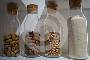 Different types of nuts in glass jars