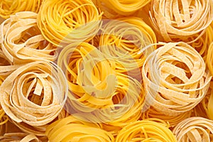 Different types of pasta as background, top view