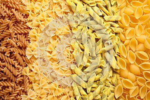 Different types of pasta as background, top view