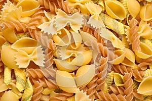 Different types of pasta as background, top view