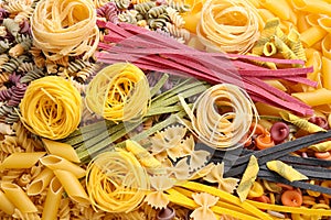 Different types of pasta as background, top view