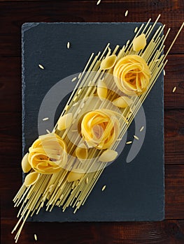 Different types of pasta on a black board