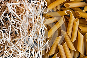 Different types of pasta on a stone background