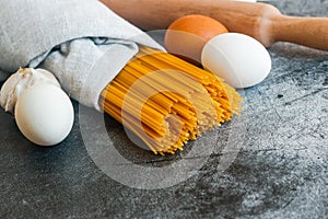 Different types of pasta on a stone background