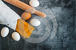 Different types of pasta on a stone background