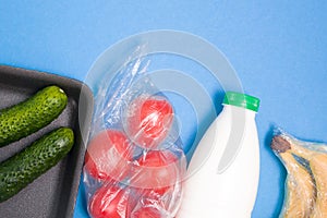 various types of plastic packaging on a blue background,