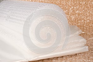 Different types of plastic packaging materials - foamed polyethylen sheets, small and large bubblewrap rolls, PE