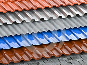 Different types of roof coating. Background from layers of sheet metal  profiles, ceramic tiles, asphalt roofing shingles and