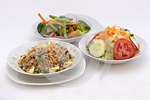 3 different types of salads: fried rice (arroz chaufa), fresh salad (tomatoes, cabage), brocoli salad photo