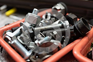 Different types of screws in a plastic box