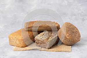 Different types of sourdough bread on light grey background