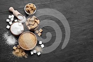 Different types of sugar on black table, flat lay. Space for text