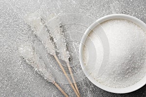 Different types of sugar on light grey table, flat lay