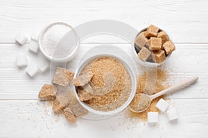 Different types of sugar on white table, flat lay