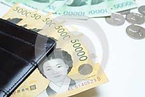 Different value South korean won currency near the wallet on white background