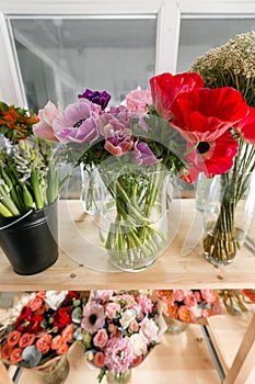 Different varieties. Fresh spring flowers in refrigerator for flowers in flower shop. Bouquets on shelf, florist